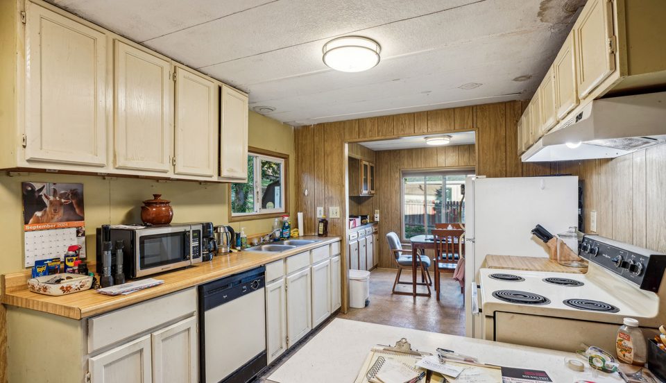 Dated kitchen with a water-stained ceiling
