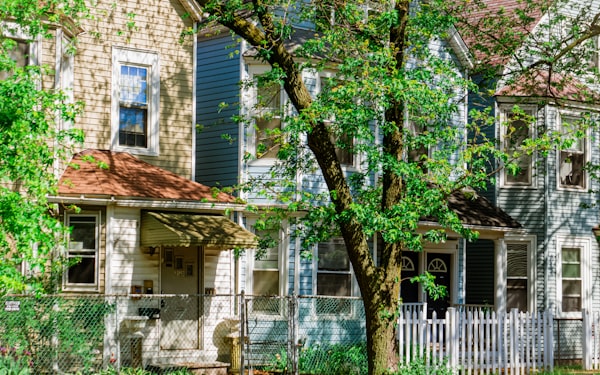 Frame worker cottage with a picket fence on a Chicago block